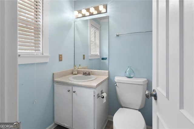 bathroom featuring toilet and vanity