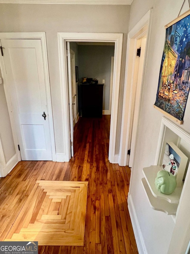 hallway with parquet flooring and baseboards