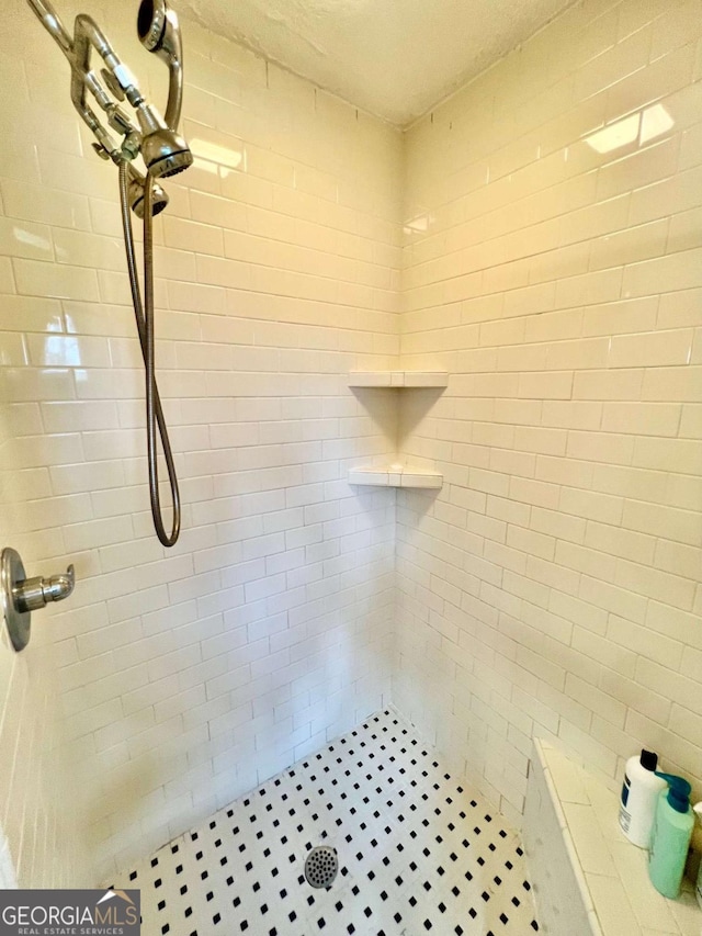 bathroom with tiled shower