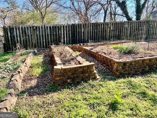 view of yard featuring a garden and a fenced backyard