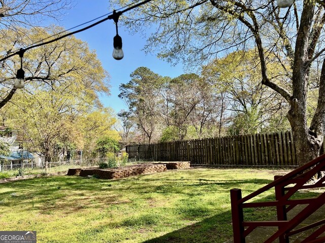 view of yard with fence and an outdoor structure