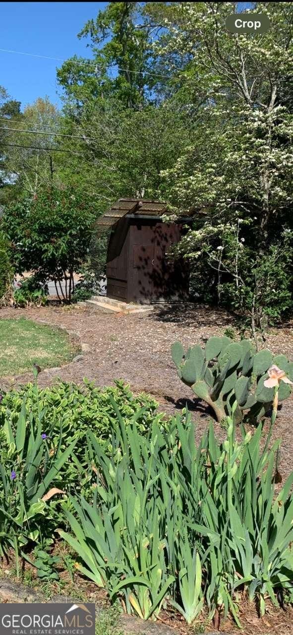 view of yard with a storage shed and an outbuilding