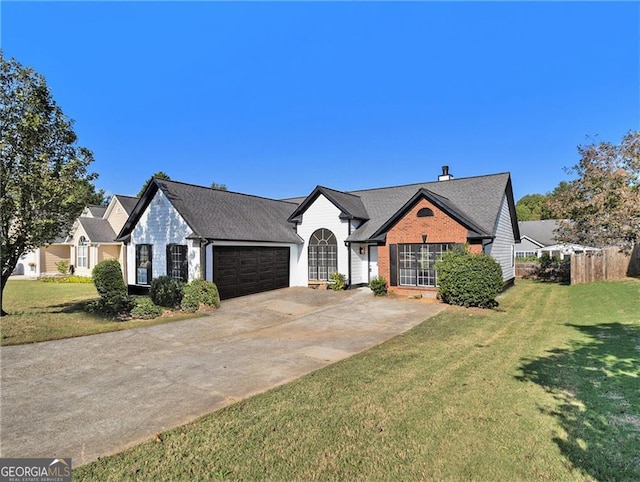 view of front of house featuring a front yard, brick siding, driveway, and an attached garage