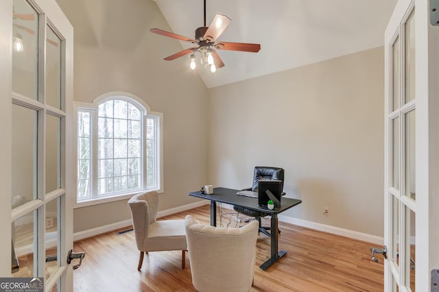 office space with french doors, baseboards, light wood-style floors, and a ceiling fan