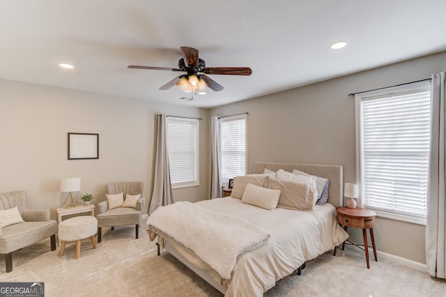 bedroom featuring recessed lighting, light colored carpet, baseboards, and ceiling fan