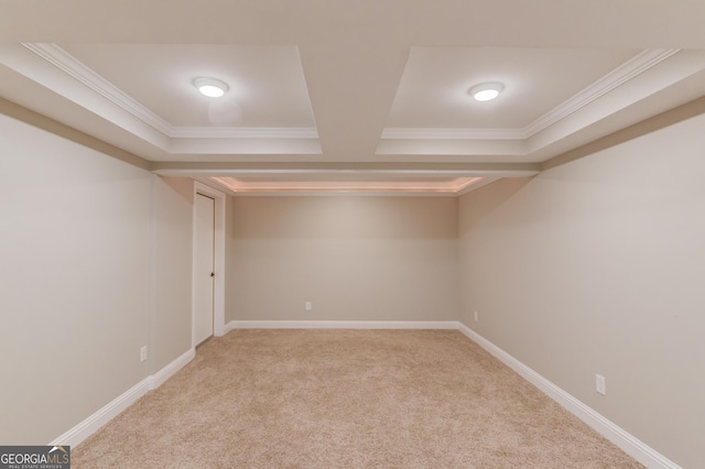 finished basement featuring baseboards, light carpet, and ornamental molding