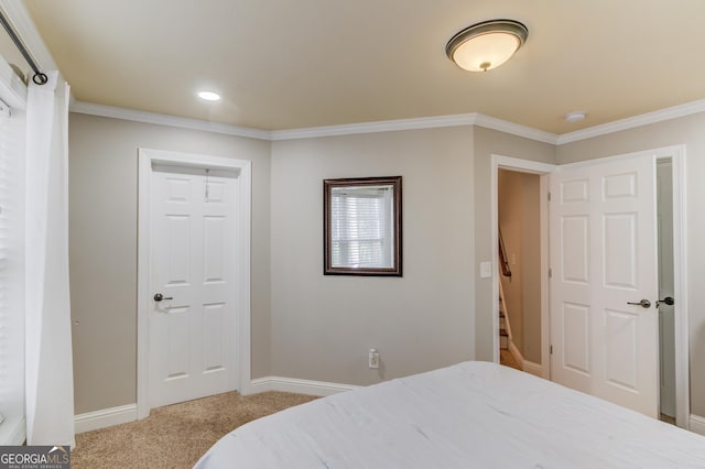 carpeted bedroom featuring baseboards and crown molding