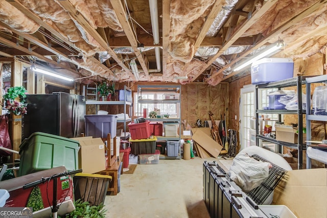 basement featuring freestanding refrigerator