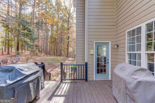 wooden deck with a grill