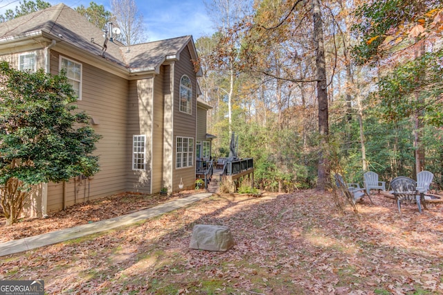 view of home's exterior with a wooden deck and stairway