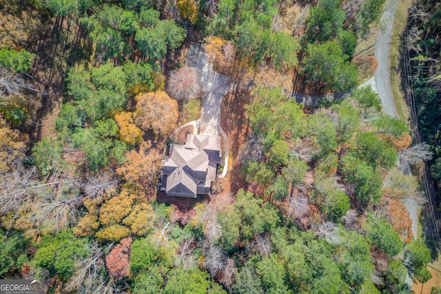 drone / aerial view featuring a wooded view