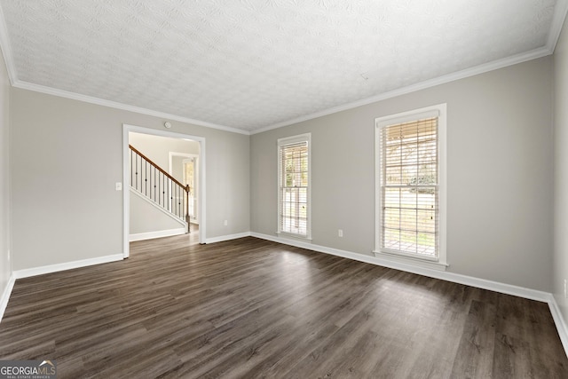 unfurnished room featuring wainscoting, ceiling fan, ornamental molding, wood finished floors, and a textured ceiling