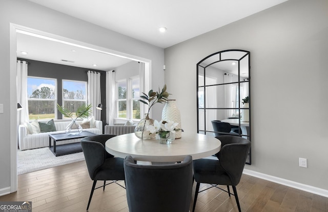 dining room featuring wood finished floors and baseboards