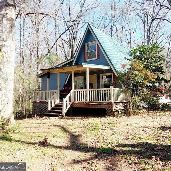 view of front of property with a porch and metal roof