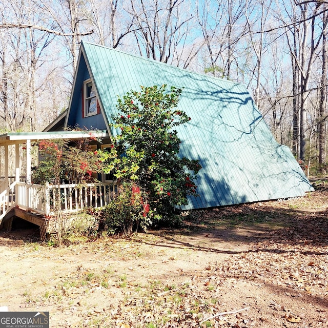 view of side of property featuring metal roof