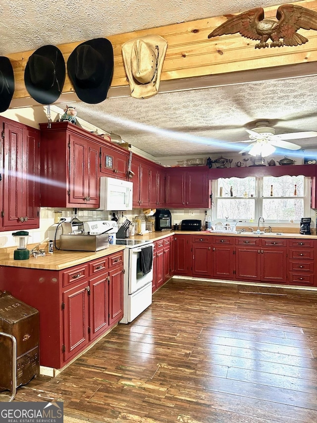 kitchen featuring a ceiling fan, a textured ceiling, dark wood-style floors, white appliances, and reddish brown cabinets