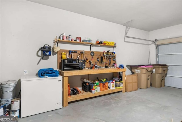 garage featuring refrigerator and a workshop area