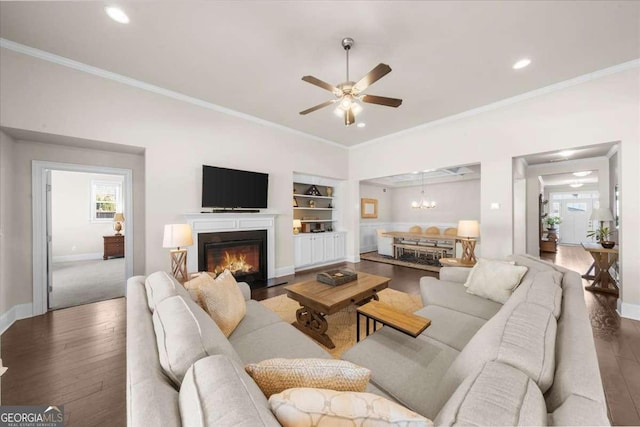 living area featuring hardwood / wood-style flooring, baseboards, built in features, and ornamental molding