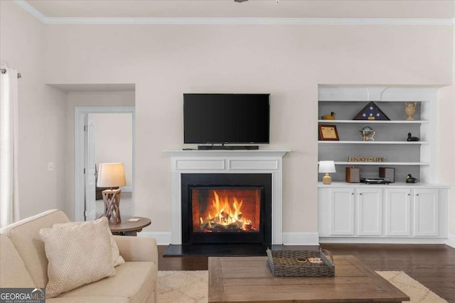 living room featuring ornamental molding, a warm lit fireplace, dark wood finished floors, and baseboards