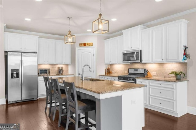 kitchen with white cabinetry, appliances with stainless steel finishes, a sink, and ornamental molding