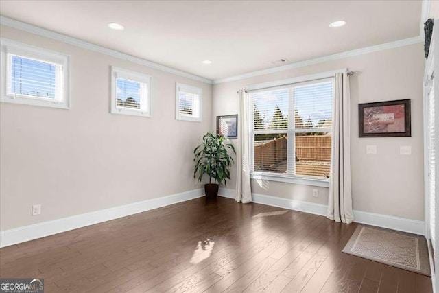 entryway featuring dark wood finished floors, crown molding, baseboards, and recessed lighting