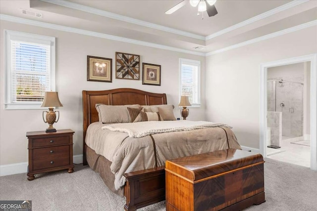 carpeted bedroom featuring visible vents, crown molding, ensuite bath, and baseboards