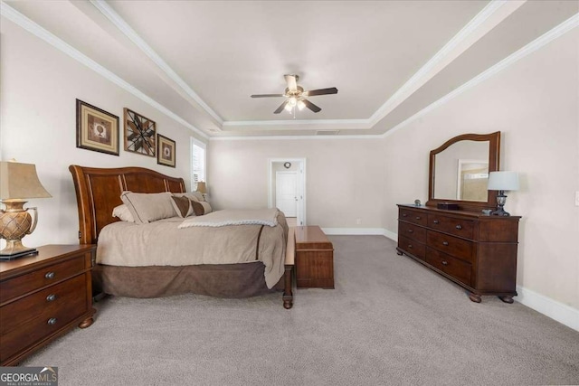 bedroom featuring baseboards, a raised ceiling, crown molding, and light colored carpet