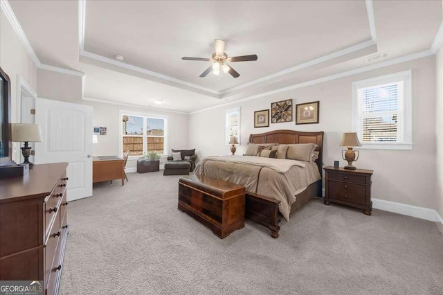 bedroom featuring visible vents, a raised ceiling, and light colored carpet