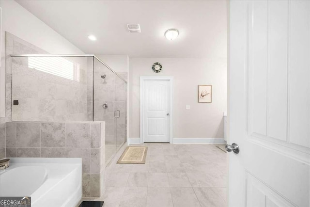 full bath with a garden tub, a shower stall, and baseboards