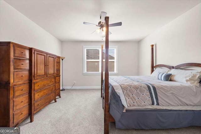 bedroom featuring light carpet, ceiling fan, and baseboards