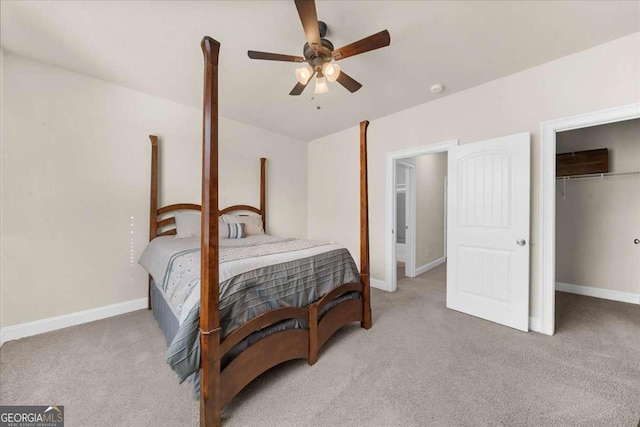 bedroom with light carpet, a ceiling fan, baseboards, and a closet