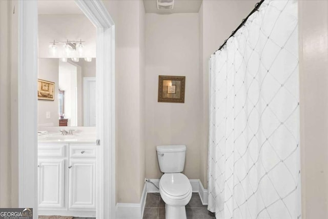 bathroom with vanity, tile patterned flooring, toilet, and baseboards