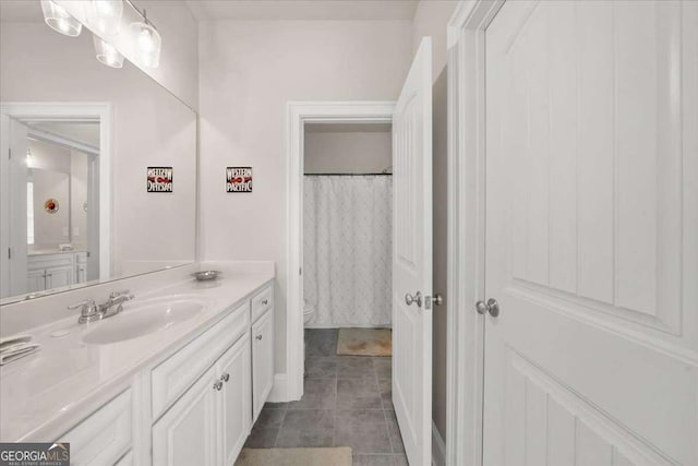 full bath with toilet, tile patterned floors, and vanity