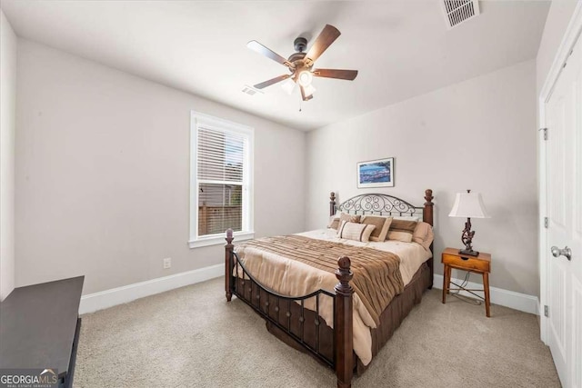 bedroom with baseboards, visible vents, a ceiling fan, and light colored carpet