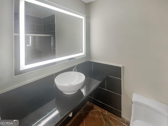 bathroom featuring a sink, toilet, and tile patterned floors