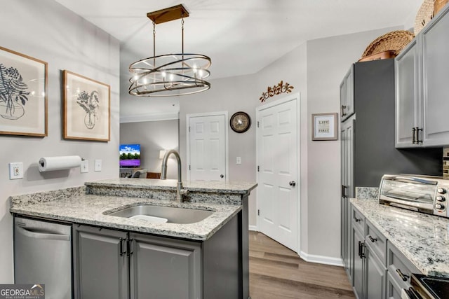 kitchen featuring a toaster, gray cabinetry, dark wood-style floors, a sink, and dishwasher