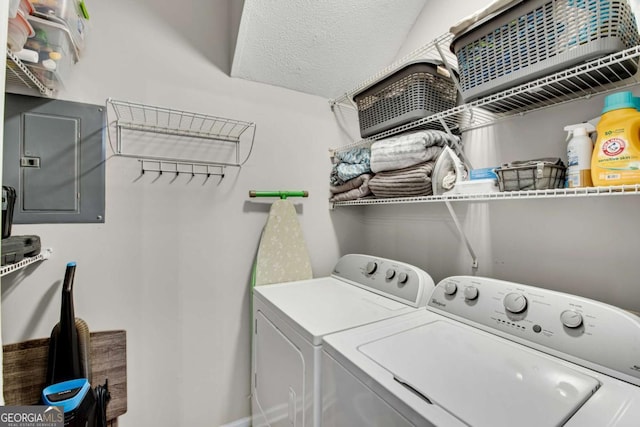 laundry area featuring a textured ceiling, laundry area, independent washer and dryer, and electric panel