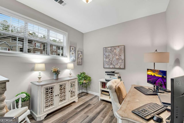 office area featuring wood finished floors, visible vents, and baseboards