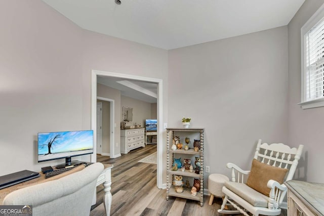 living area with light wood finished floors and baseboards