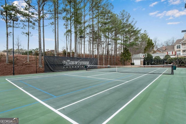 view of sport court featuring fence