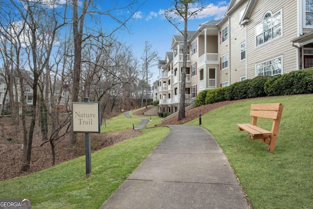 view of property's community featuring a residential view and a lawn