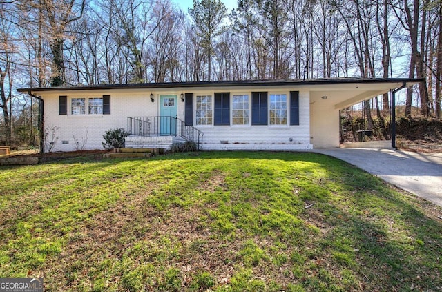 single story home featuring brick siding, driveway, crawl space, a carport, and a front yard