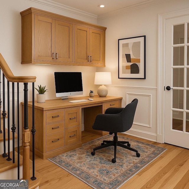 office space featuring light wood-style floors and crown molding