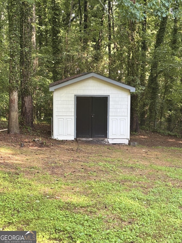view of shed featuring a view of trees