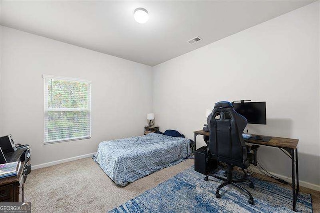 bedroom featuring carpet floors, visible vents, and baseboards