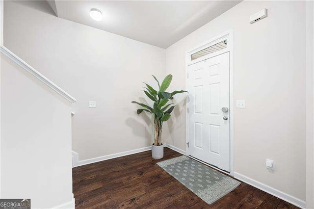 foyer with wood finished floors and baseboards