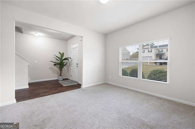 spare room with carpet and baseboards