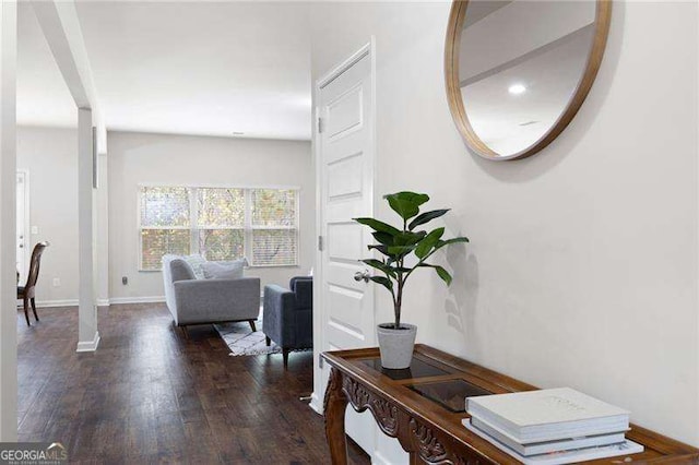 interior space with baseboards and wood finished floors