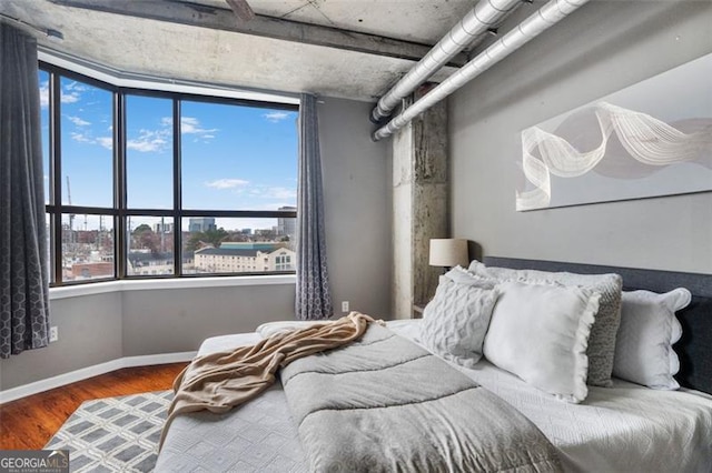 bedroom featuring baseboards and wood finished floors