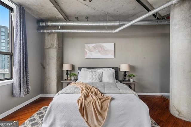 bedroom with wood finished floors and baseboards